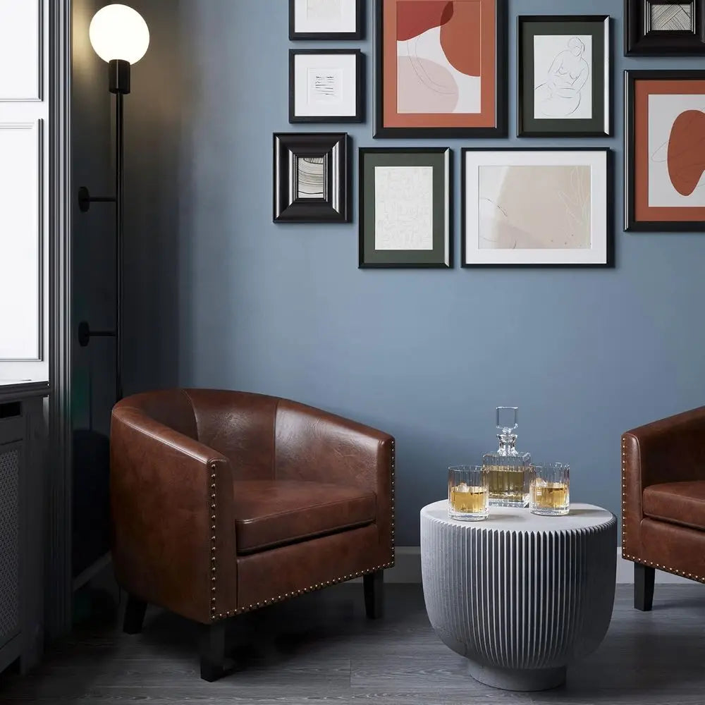 Pair of Elegant Leather Tub Chairs with Gold Nailhead Trim and Black Legs for Living Spaces