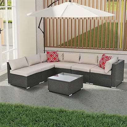 beige rattan wicker outdoor patio sectional set with coffee table and two pillows