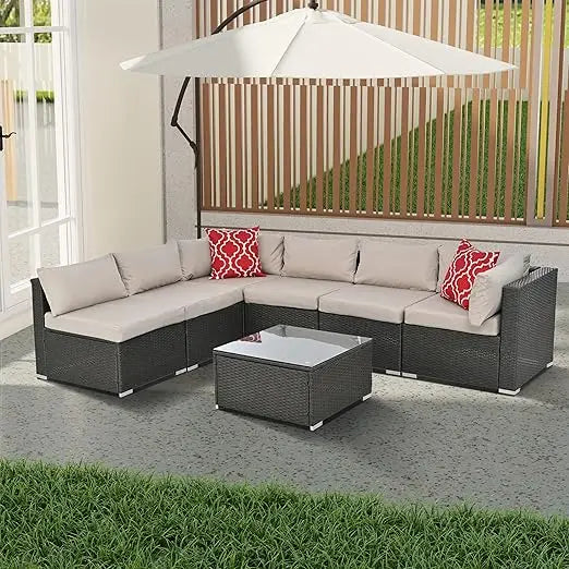 beige rattan wicker outdoor patio sectional set with coffee table and two pillows