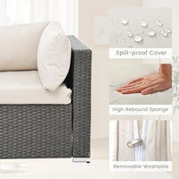 beige rattan wicker outdoor patio sectional set with coffee table and two pillows