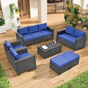 beige rattan wicker outdoor patio sectional set with coffee table and two pillows
